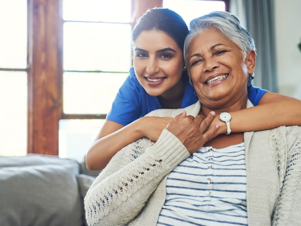 caregiver giving support to elderly