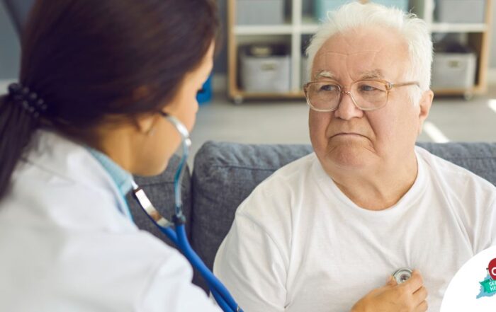 A doctor examines an older man with a stethoscope, representing pneumonia in elderly adults.