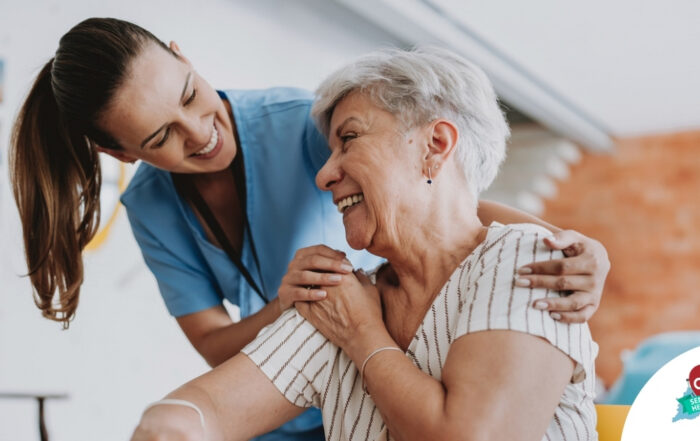 A female caregiver helping an older woman with stroke recovery at home.